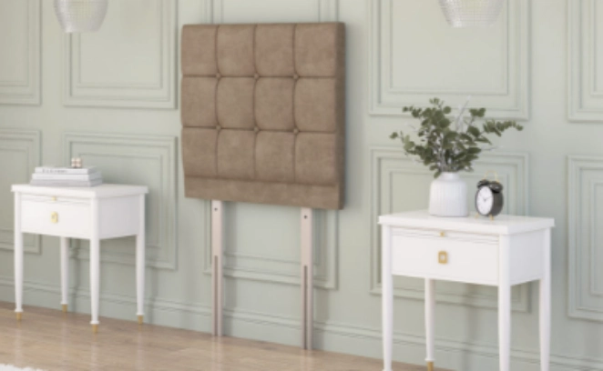Chesterfield floor standing headboard in beige velvet, displayed between two black bedside tables in a classic interior.